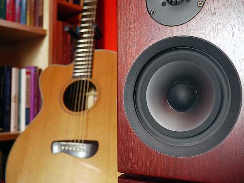 leisure activities brown guitar behind speaker speaker